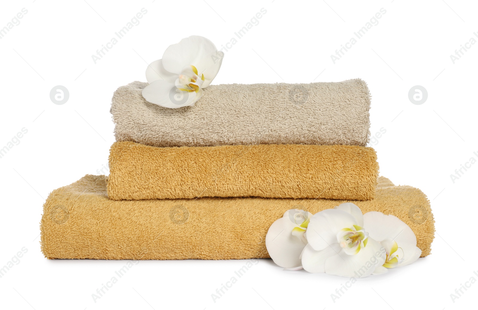 Photo of Stack of clean soft towels with orchids isolated on white