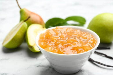 Photo of Delicious pear jam and fresh fruits on white marble table, closeup