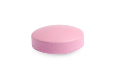 One pink pill on white background. Medicinal treatment