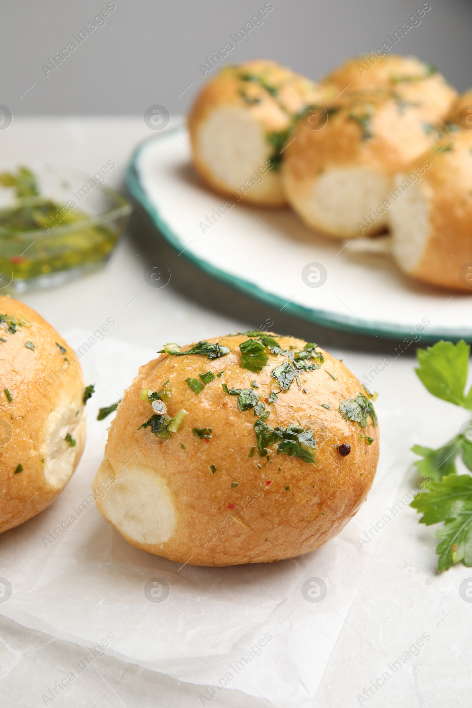 Photo of Traditional Ukrainian bread (Pampushky) with garlic on light table