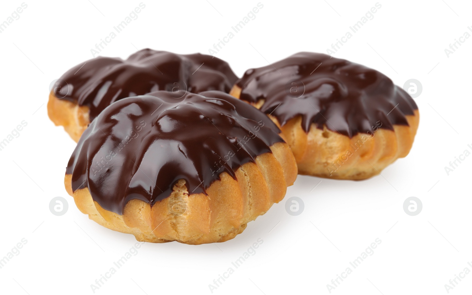 Photo of Delicious profiteroles with chocolate spread isolated on white