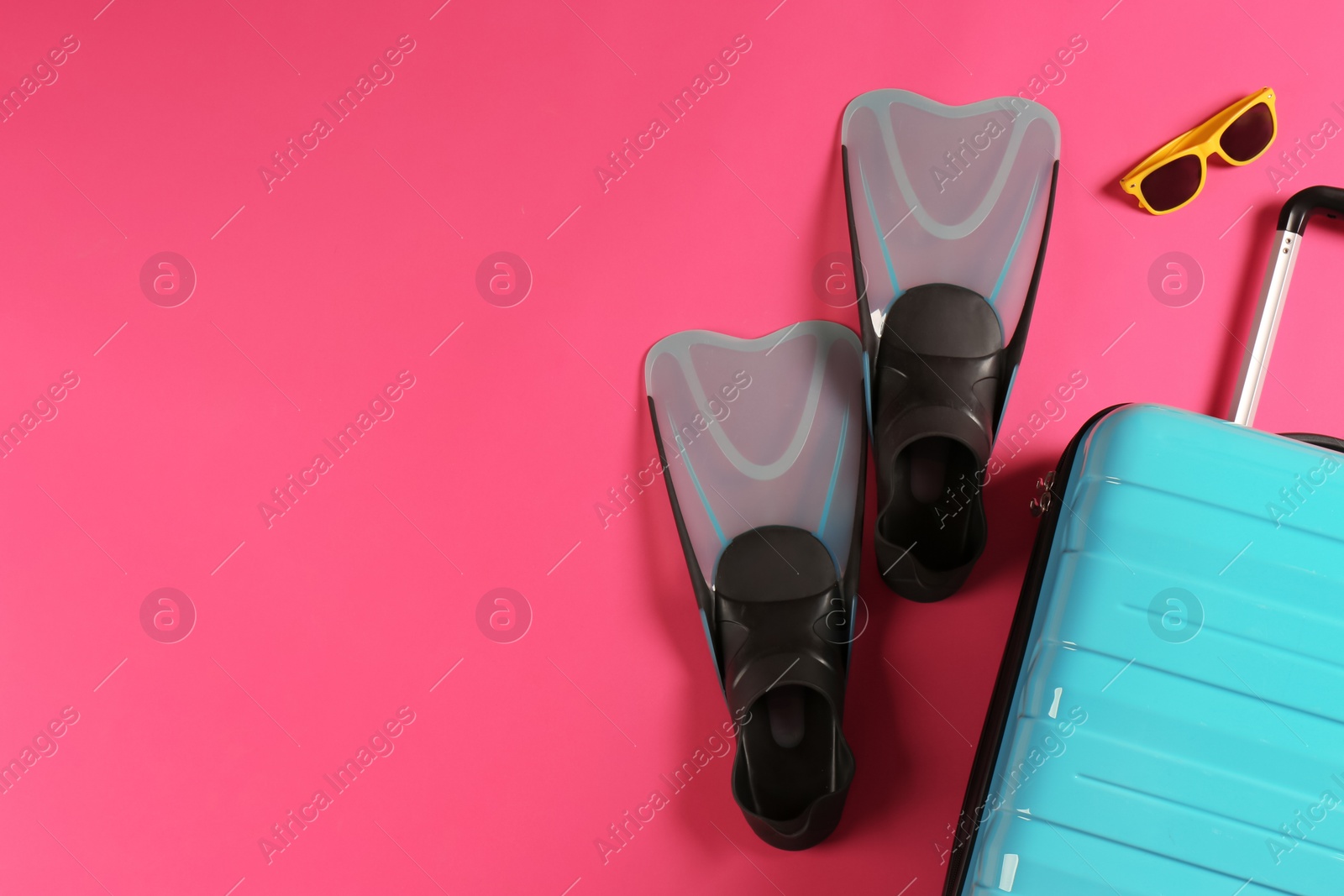 Photo of Flat lay composition with suitcase and beach items on color background. Space for text