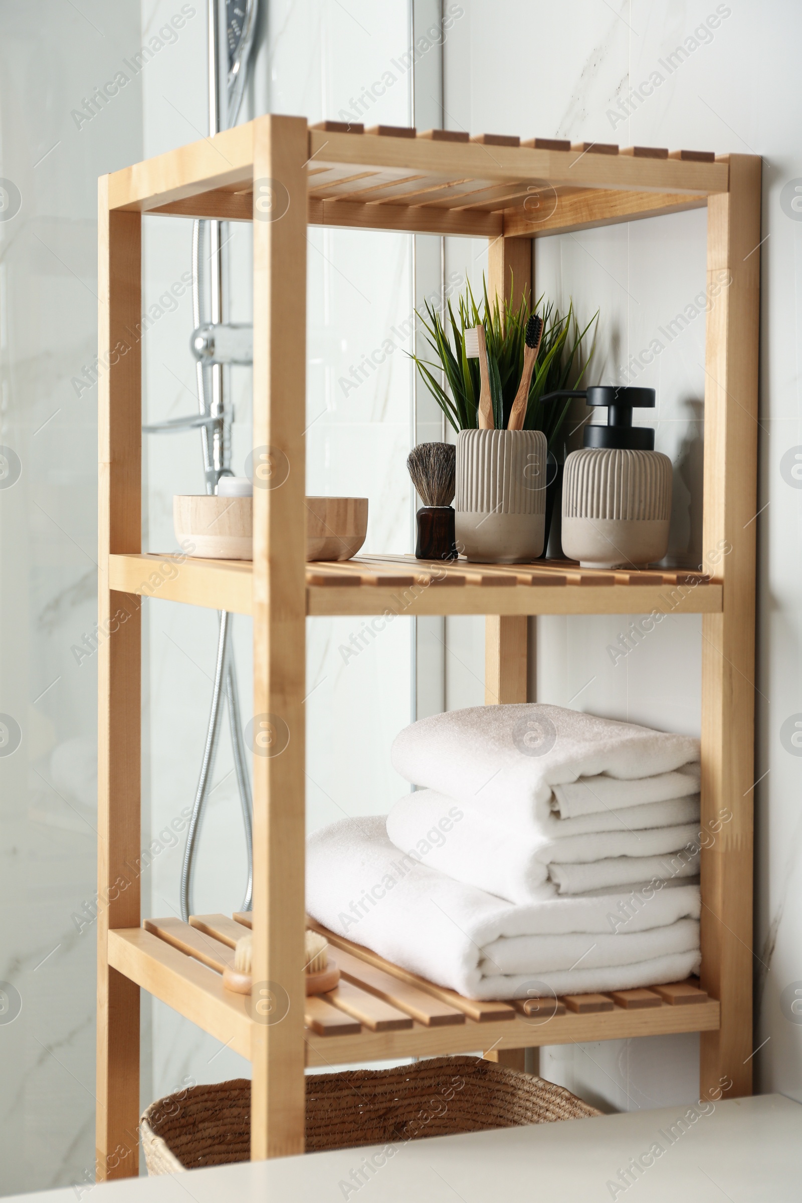 Photo of Shelving unit with toiletries in bathroom interior