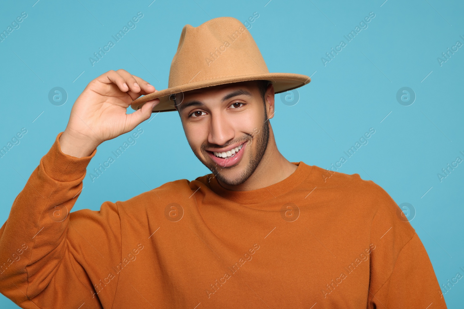 Photo of Portrait of happy African American man on light blue background