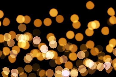 Beautiful golden lights on dark background. Bokeh effect