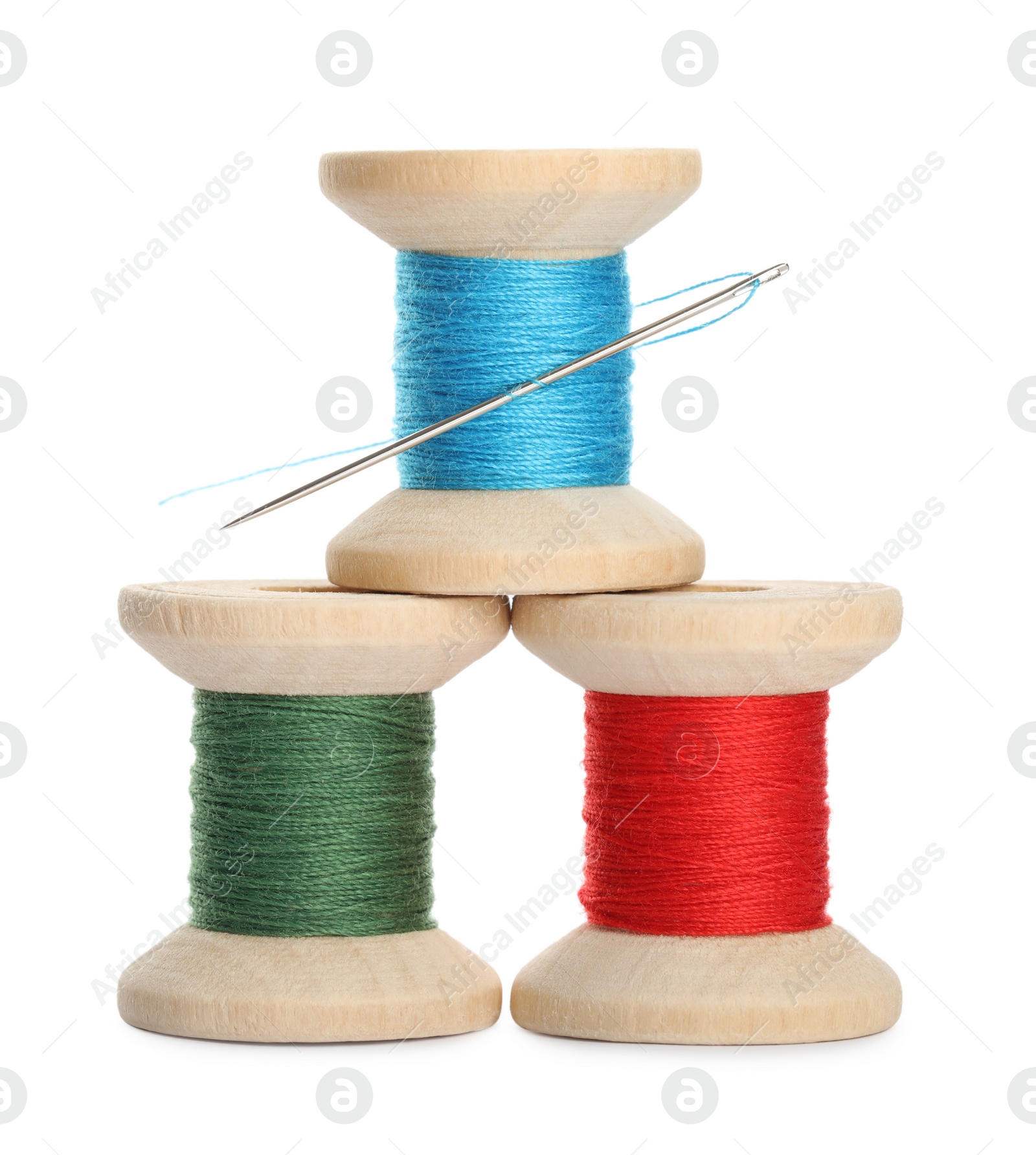 Photo of Different colorful sewing threads with needle on white background