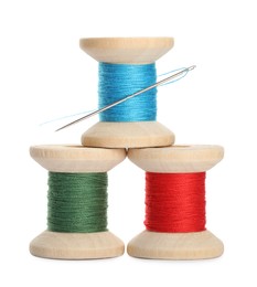 Photo of Different colorful sewing threads with needle on white background