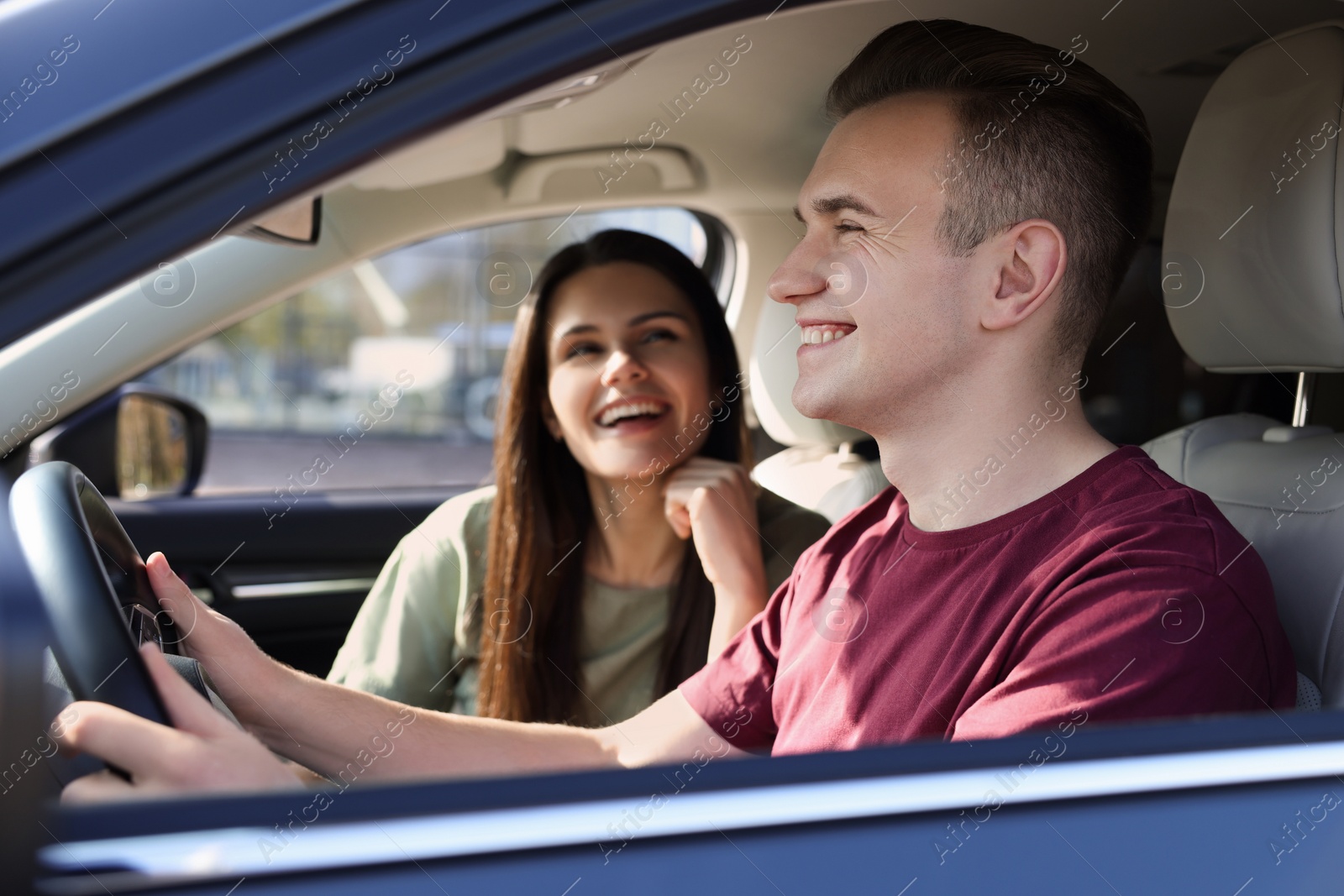 Photo of Happy young couple travelling together by car