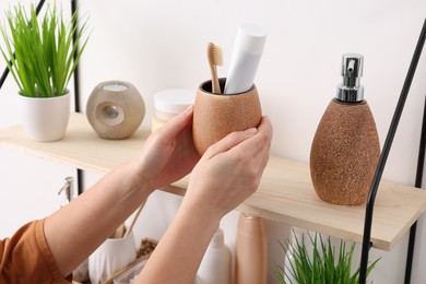 Bath accessories. Woman organizing personal care products indoors, closeup