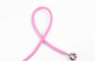 Photo of Pink stethoscope isolated on white, top view. Breast cancer awareness