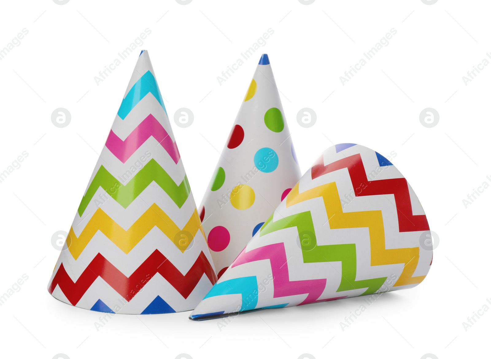 Photo of Bright party hats on white background. Festive accessory