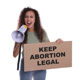 Emotional African American woman shouting into megaphone and holding placard with phrase Keep Abortion Legal on white background. Abortion protest