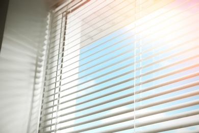 Beautiful view through window with blinds on sunny day