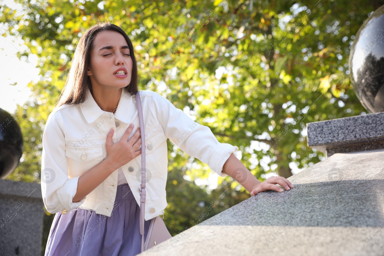 Photo of Young woman having heart attack in park