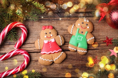 Image of Flat lay composition with gingerbread couple on wooden table