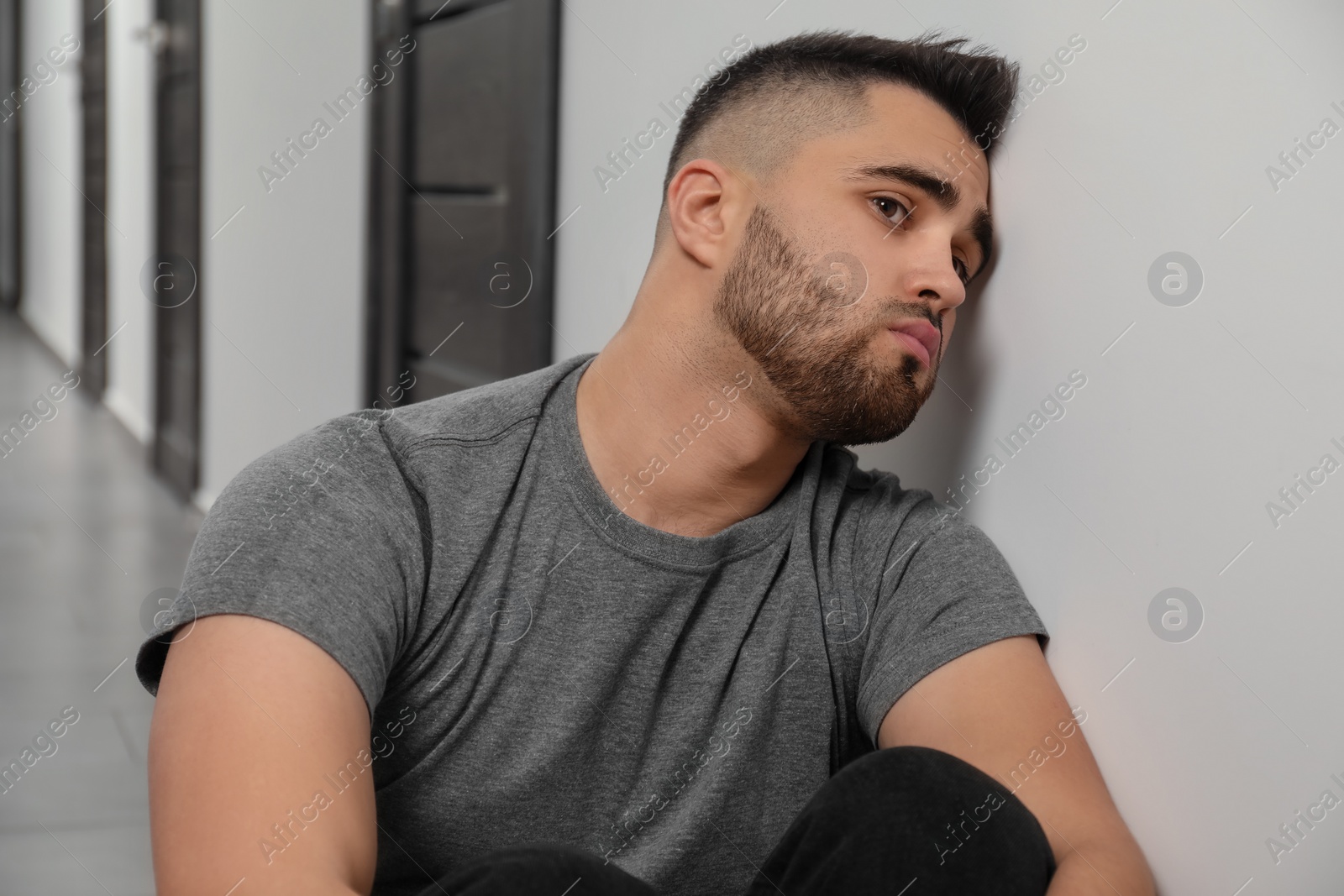 Photo of Portrait of sad young man in hall