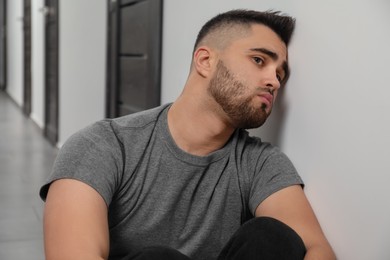 Photo of Portrait of sad young man in hall