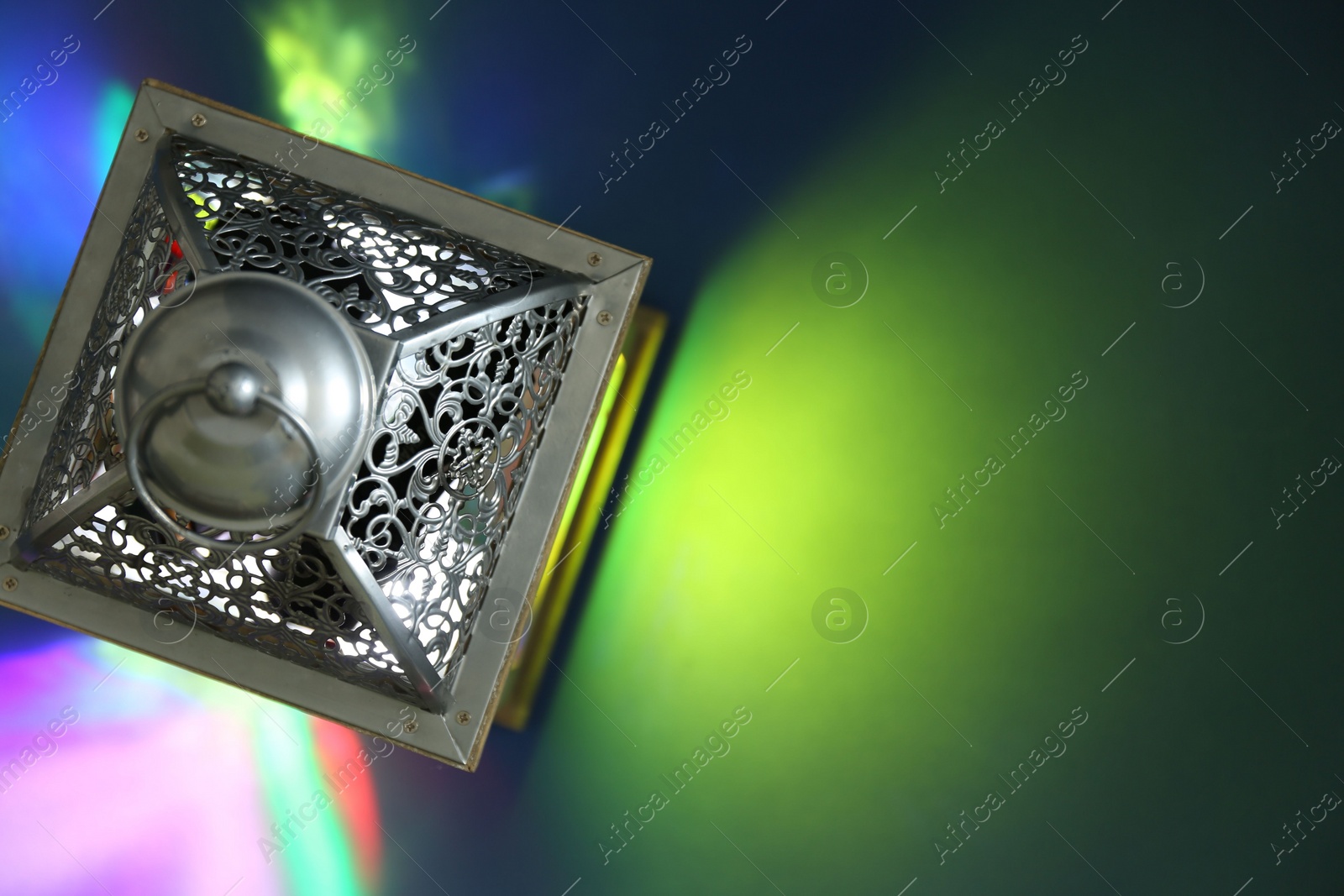 Photo of Decorative Arabic lantern on color background, top view. Space for text