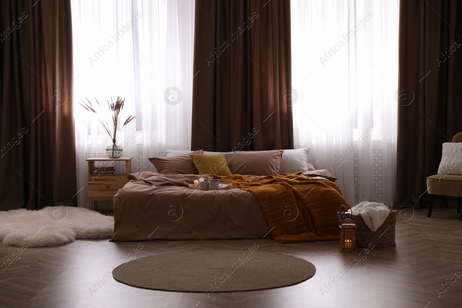 Photo of Bed with brown linens in stylish room interior