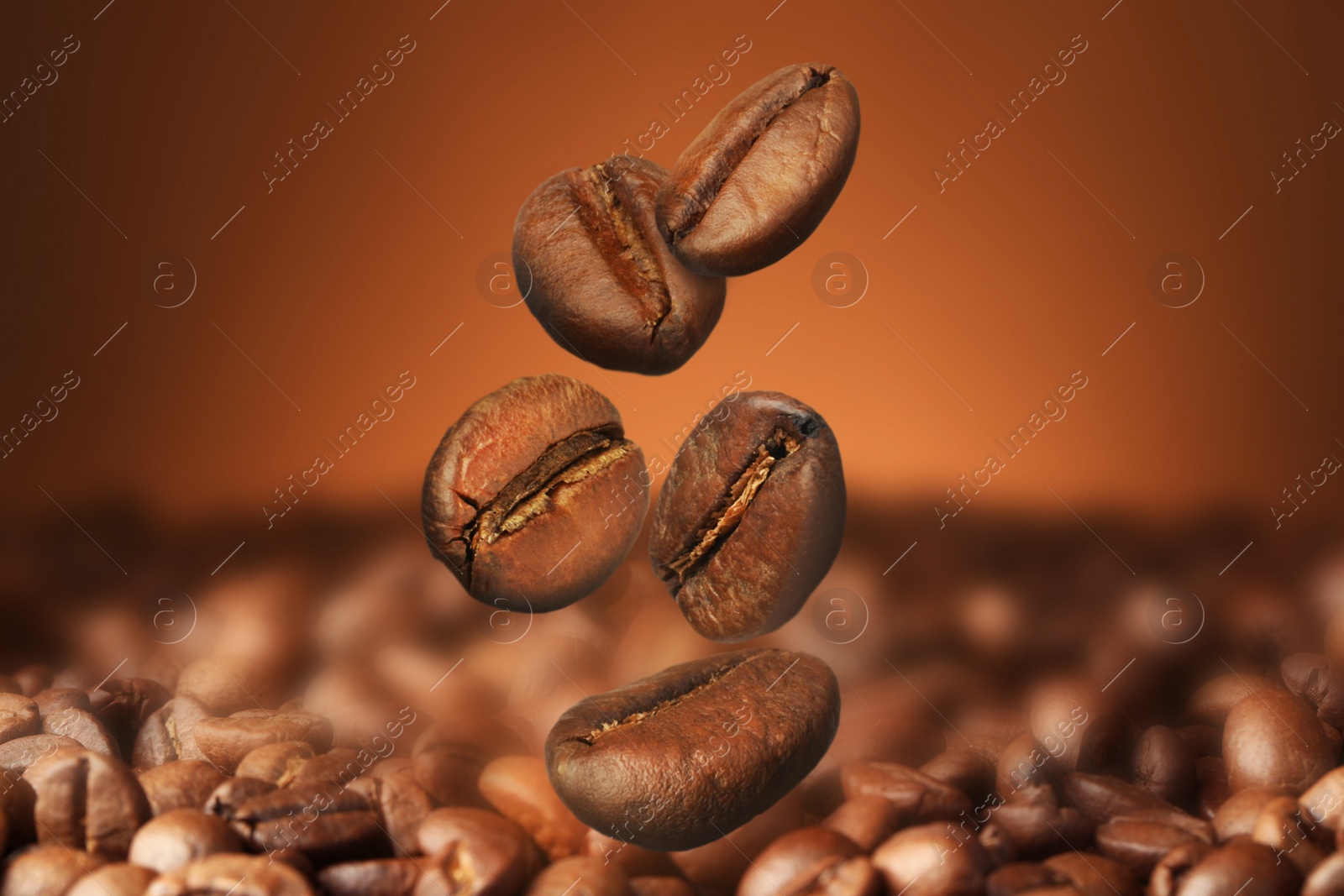 Image of Falling aromatic roasted coffee beans, closeup view