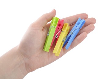 Woman holding colorful plastic clothespins on white background, closeup