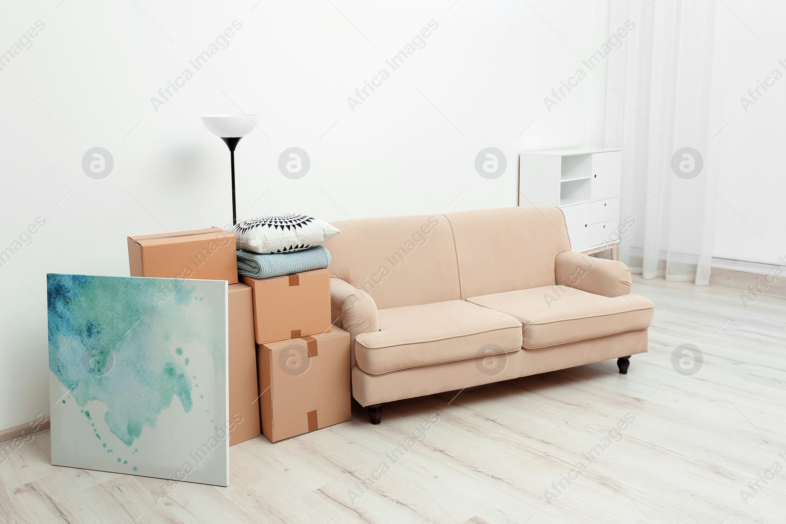 Photo of Moving boxes and household stuff in living room