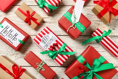 Different Christmas gift boxes on white wooden background, Flat lay