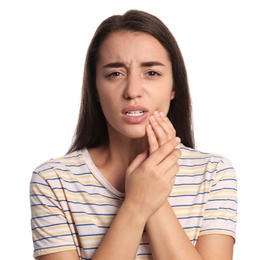 Young woman suffering from toothache on white background