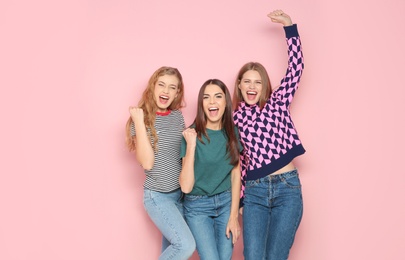 Photo of Young women celebrating victory on color background
