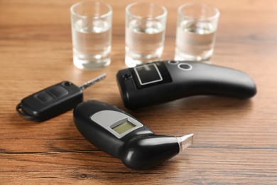 Photo of Composition with modern breathalyzers on wooden table