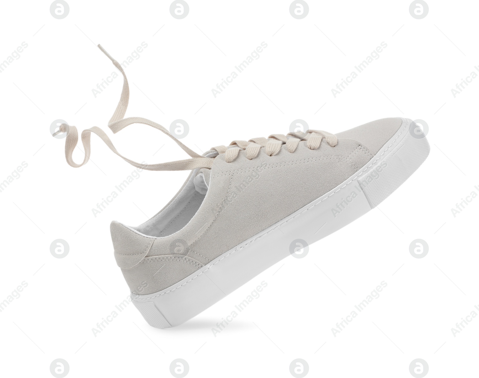 Photo of One stylish beige sneaker isolated on white