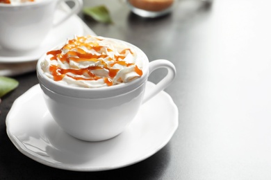 Photo of Cup of coffee with caramel topping on table