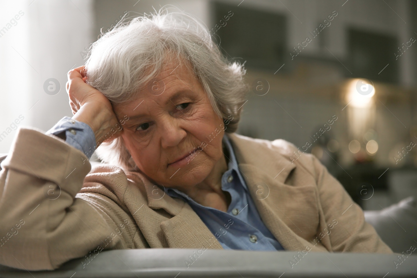 Photo of Portrait of elderly woman on sofa at home