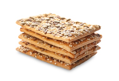 Stack of delicious crispy crackers with different seeds isolated on white