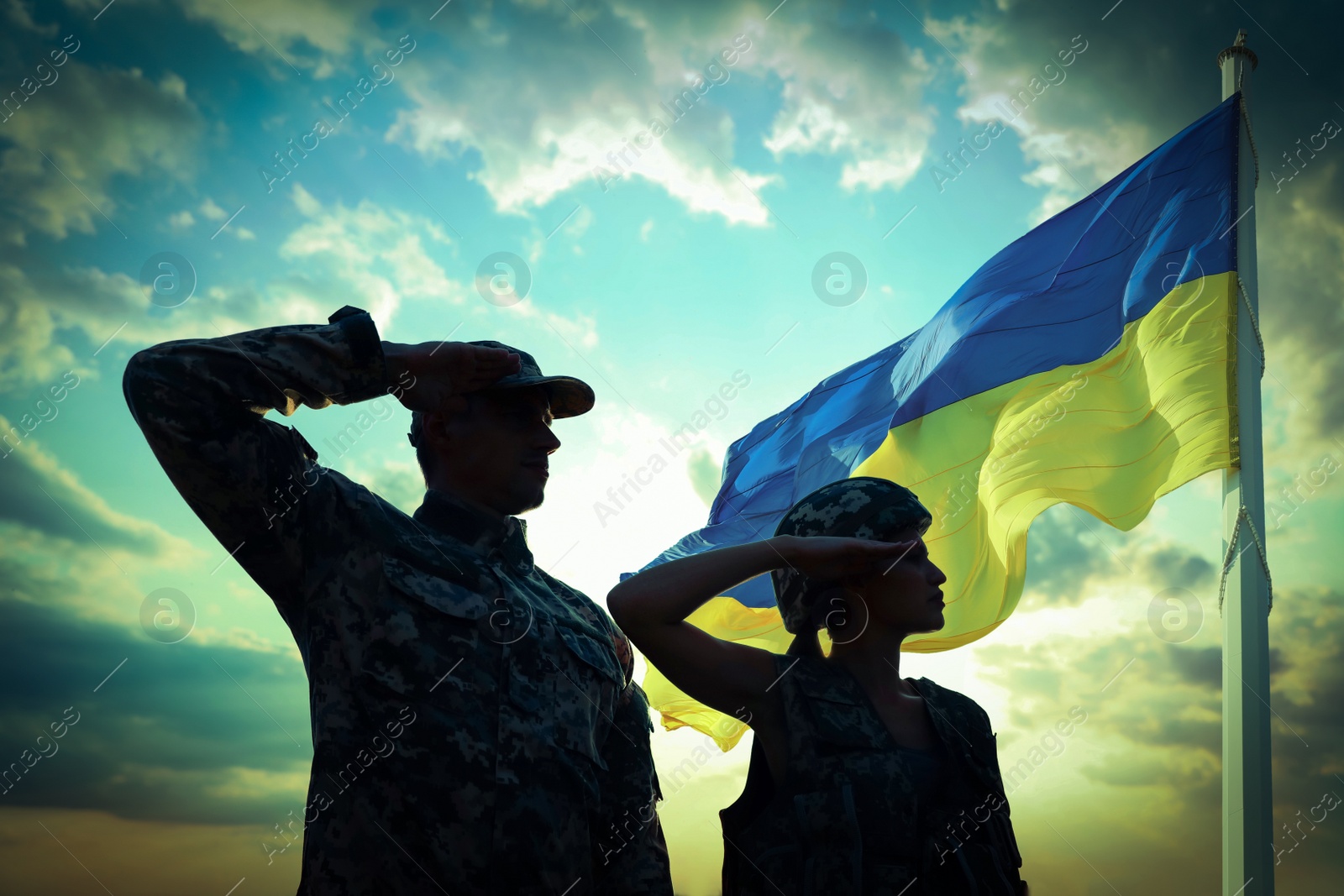 Image of Stop war in Ukraine. Silhouette of soldiers saluting to Ukrainian flag outdoors