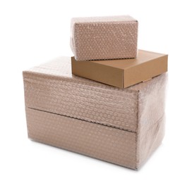 Photo of Cardboard boxes packed in bubble wrap and ordinary one on white background