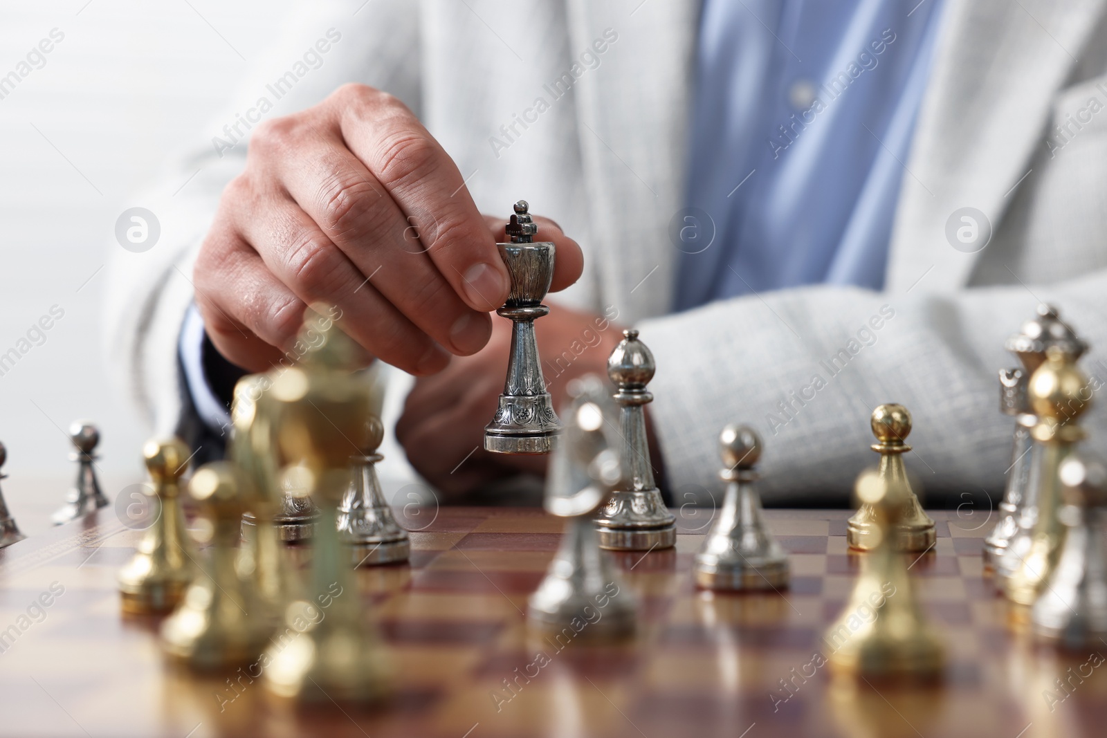 Photo of Man playing chess during tournament at chessboard, closeup