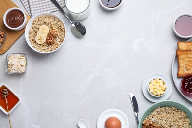 Photo of Flat lay composition with tasty breakfast food on light grey marble table. Space for text
