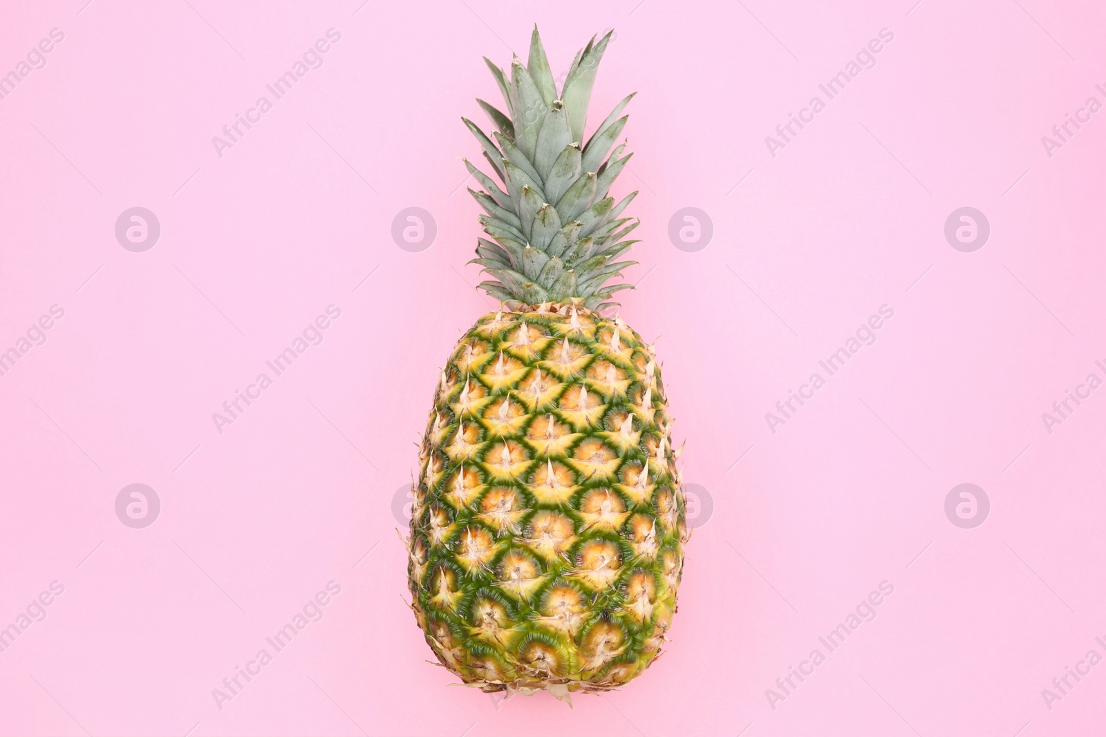 Photo of Delicious ripe pineapple on pink background, top view