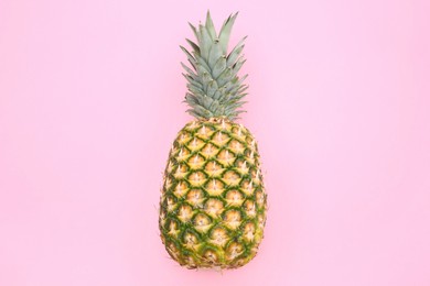 Delicious ripe pineapple on pink background, top view