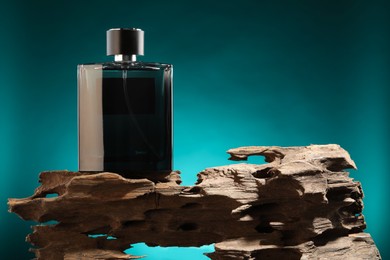 Photo of Luxury men`s perfume in bottle against color background, space for text