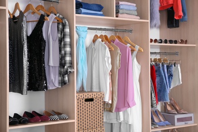 Large wardrobe with different clothes and shoes