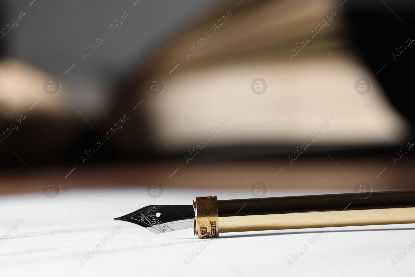 Photo of Fountain pen and paper document on table, closeup. Notary service