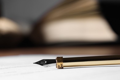 Fountain pen and paper document on table, closeup. Notary service