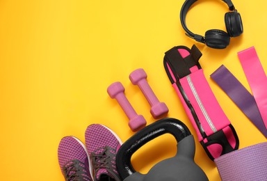 Photo of Different sports equipment on yellow background, flat lay. Space for text