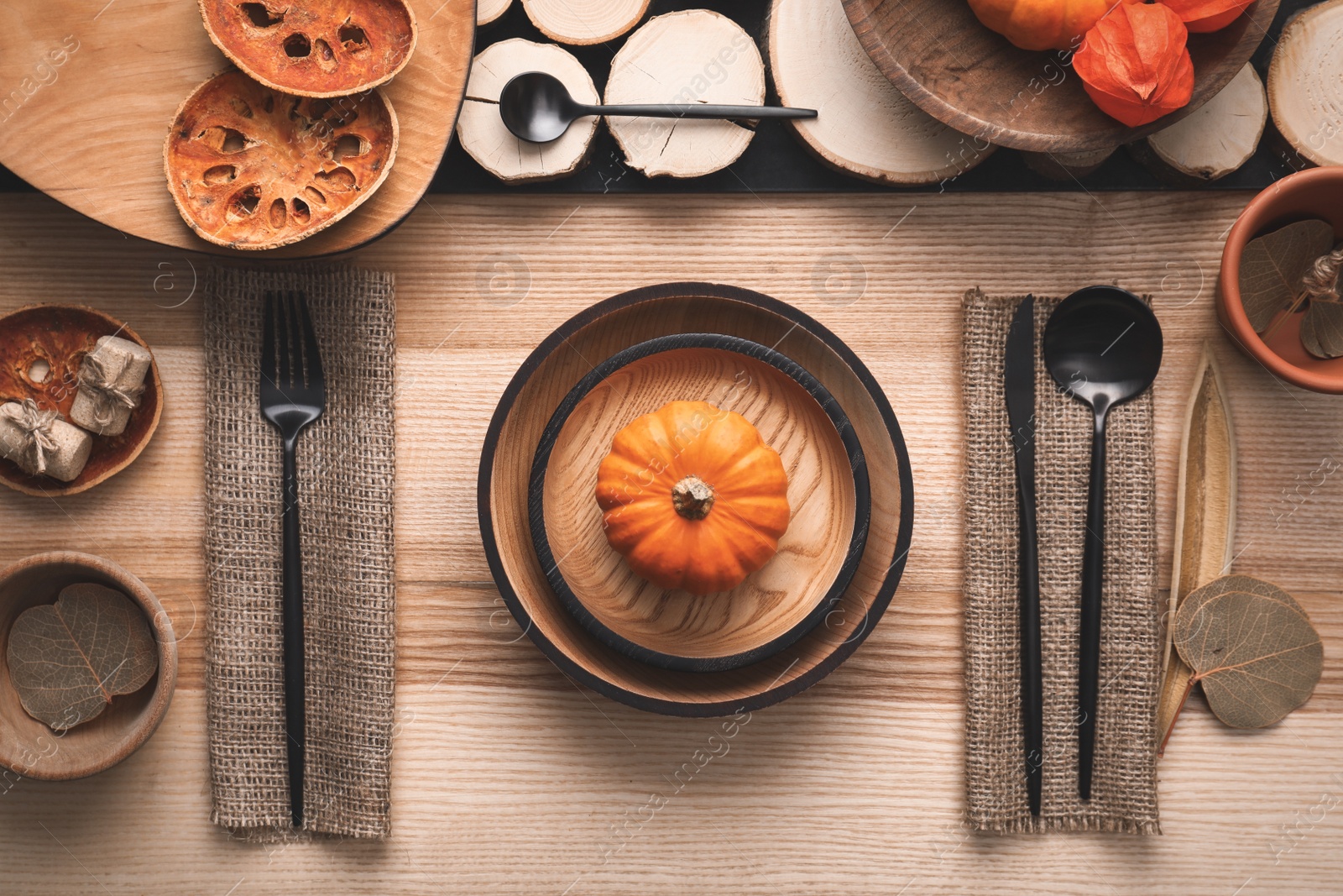 Photo of Autumn table setting with pumpkin on wooden background, flat lay