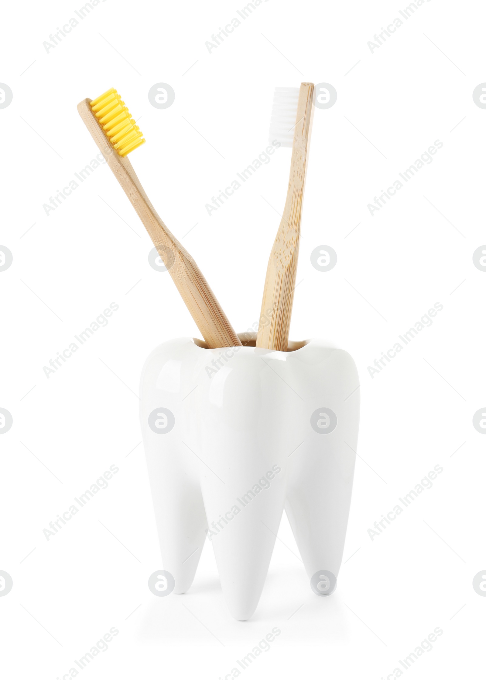 Photo of Tooth shaped holder with brushes on white background