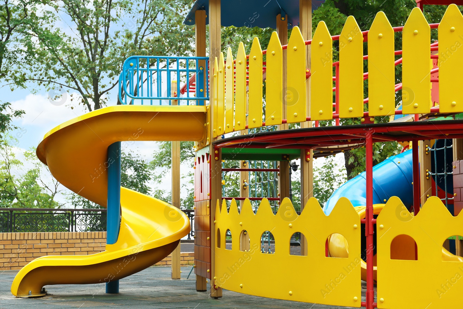 Photo of New colorful castle playhouse with slide on children's playground