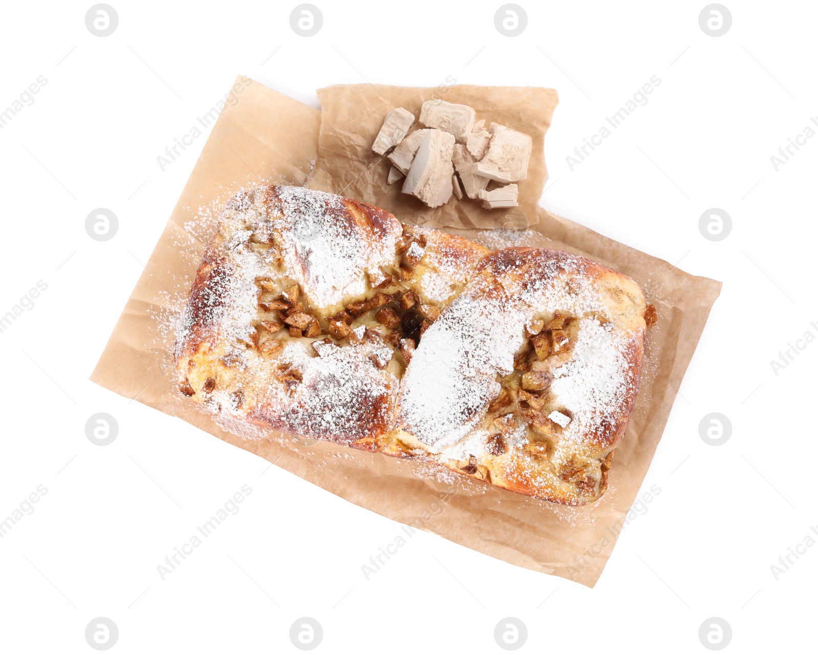 Photo of Delicious cake and pieces of compressed yeast on white background, top view