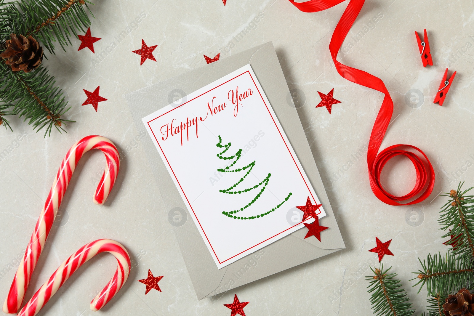 Image of Greeting card with text Happy New Year and Christmas decor on grey marble table, flat lay